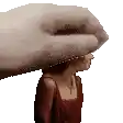 a hand is holding a woman 's head in a pixel art style .