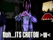 a man wearing headphones making a heart shape with his hands and the words nah its croton > w <