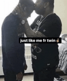a man kissing another man on the forehead with the words just like me fr twin below them