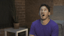 a man singing into a rode microphone with his mouth open