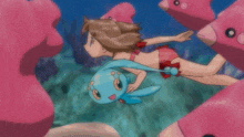 a girl in a pink bikini is swimming with a blue bunny