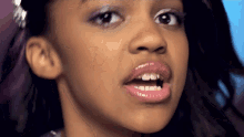 a close up of a little girl 's face with a missing tooth