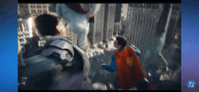 a man in a superman cape is fighting a robot