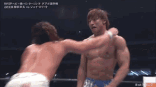 two wrestlers are wrestling in a ring with a banner that says iwgp