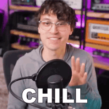 a man in front of a microphone with the word chill written on it