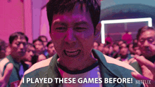 a man is standing in front of a crowd and says " i played these games before "