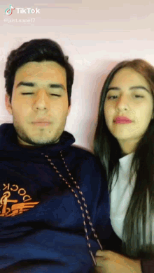 a man and a woman are standing next to each other with tiktok written on the bottom right