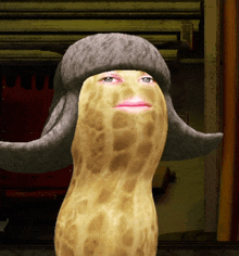 a peanut wearing a hat with a female face on it
