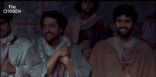 a man with curly hair and a beard is in a scene from the chosen
