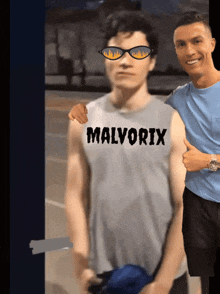 a man wearing a shirt that says malvorix stands next to another man
