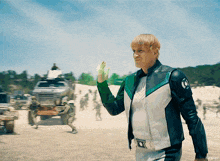 a man in a white and green jacket with the letter o on the sleeve