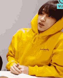 a person wearing a yellow hoodie that says mark smith on the front