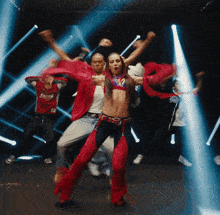 a group of people are dancing and one of them is wearing a shirt that says racing