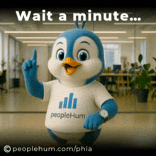 a penguin mascot is wearing a peoplehum shirt and pointing up