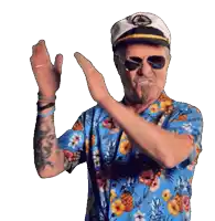 a man wearing a captain hat and sunglasses is clapping his hands