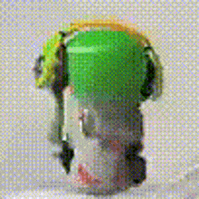 a close up of a green object on a white surface