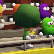 a group of cartoon characters are sitting in a stadium including a green broccoli