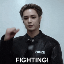 a man wearing a polizei jacket is fighting