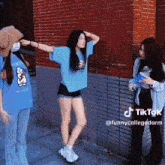 a girl wearing a blue shirt that says ' funny college dorm '