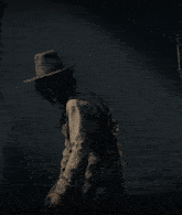 a woman wearing a cowboy hat and a belt of bullets