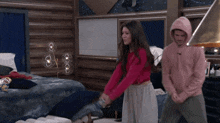 a girl in a pink sweater is holding a bottle