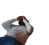 a man in a white shirt and blue pants is laying down