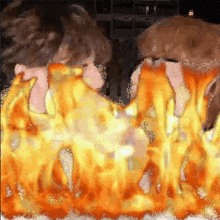 a painting of two people standing next to each other with flames behind them