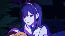 a girl with bunny ears on her head is holding a cookie