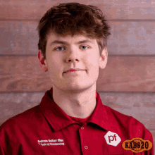 a young man wearing a red shirt with pf on the front