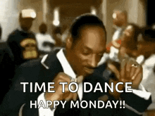 snoop dogg is wearing a suit and tie and is dancing in a crowd .