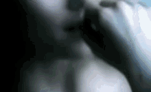 a blurry picture of a person 's face with a hand on it .