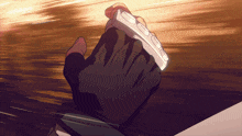 a close up of a person 's hand holding a white object