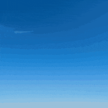 a white airplane is flying through a blue sky with clouds