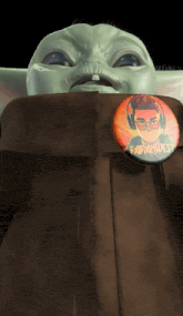 a baby yoda with a button that says fabianwest on it