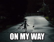 a silhouette of a person running down a street with the words on my way below them