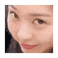 a close up of a woman 's face with a red lip and a black spot on her cheek .