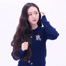 a woman wearing a blue sweater with the letters rl on the front