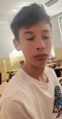 a boy wearing a white shirt that says have a good time on it