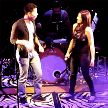 a man and a woman are dancing on a stage with rbd gif written on the bottom