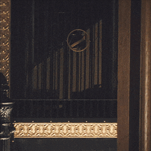 a dark room with a clock on the wall with the letter z on it