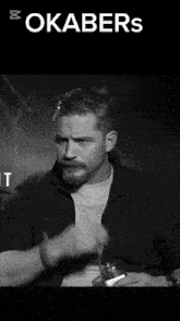a black and white photo of a man with the words okabers on the top