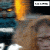 a blurry picture of a man with ang candil written on the bottom right