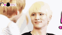 a man with blonde hair is standing next to another man and looking at the camera .