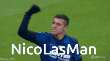 a man in a blue shirt with the name nicolas man written on it