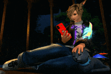 a person sitting on the floor with a cat and holding a red phone that says ' kitty ' on it