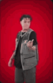 a man is dancing in front of a red background while holding money in his hands .