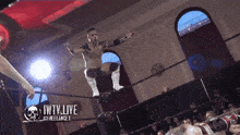 a wrestler in a ring with the words iwtv.live on the bottom