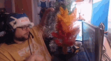 a man wearing a santa hat that says jesus loves