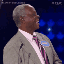 a man wearing a suit and tie has a name tag that says george