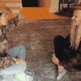 a man and a woman are sitting on the floor and talking